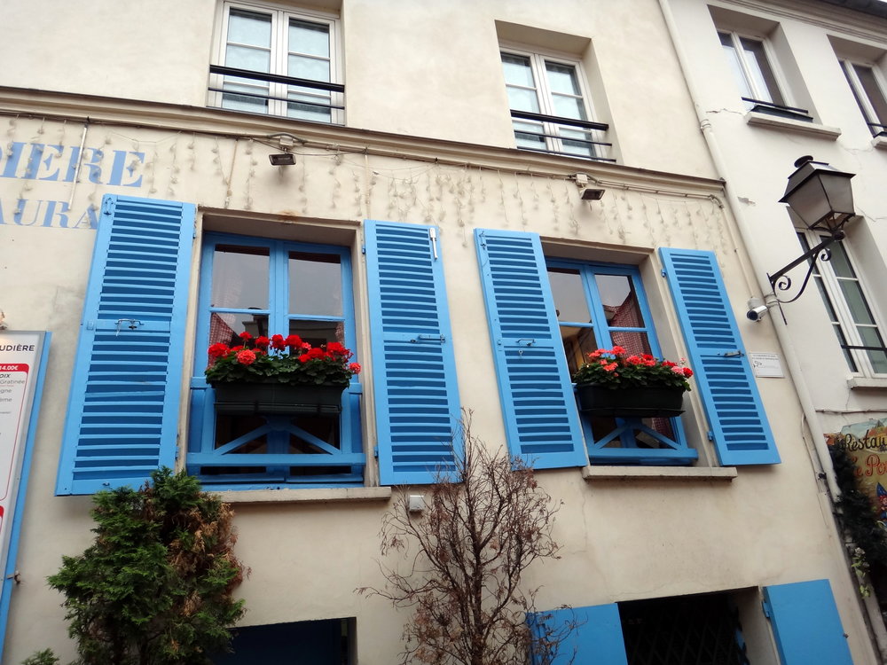 photo credit: Carolyn Marquardt  / Blue shutters and flowers in Paris