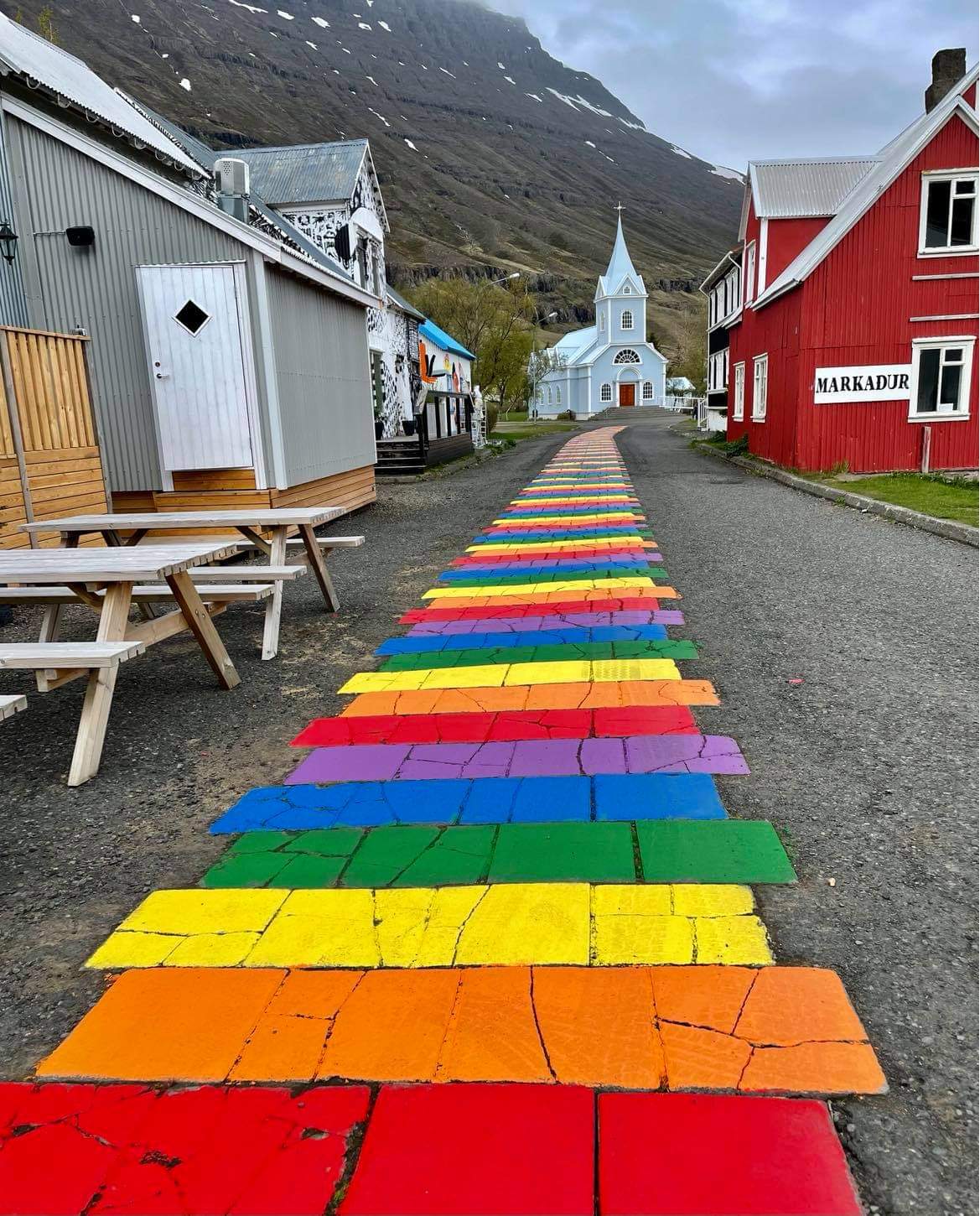 rainbow bricks leading to church in Seyðisfjörður