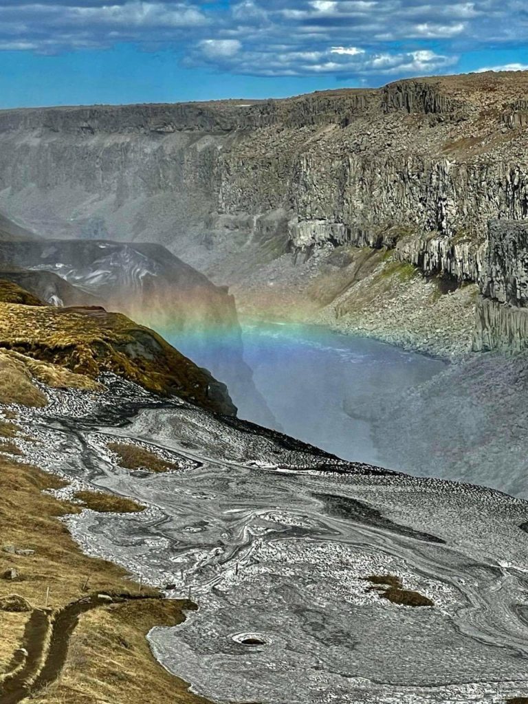 travel views: rainbow across a gorge in iceland